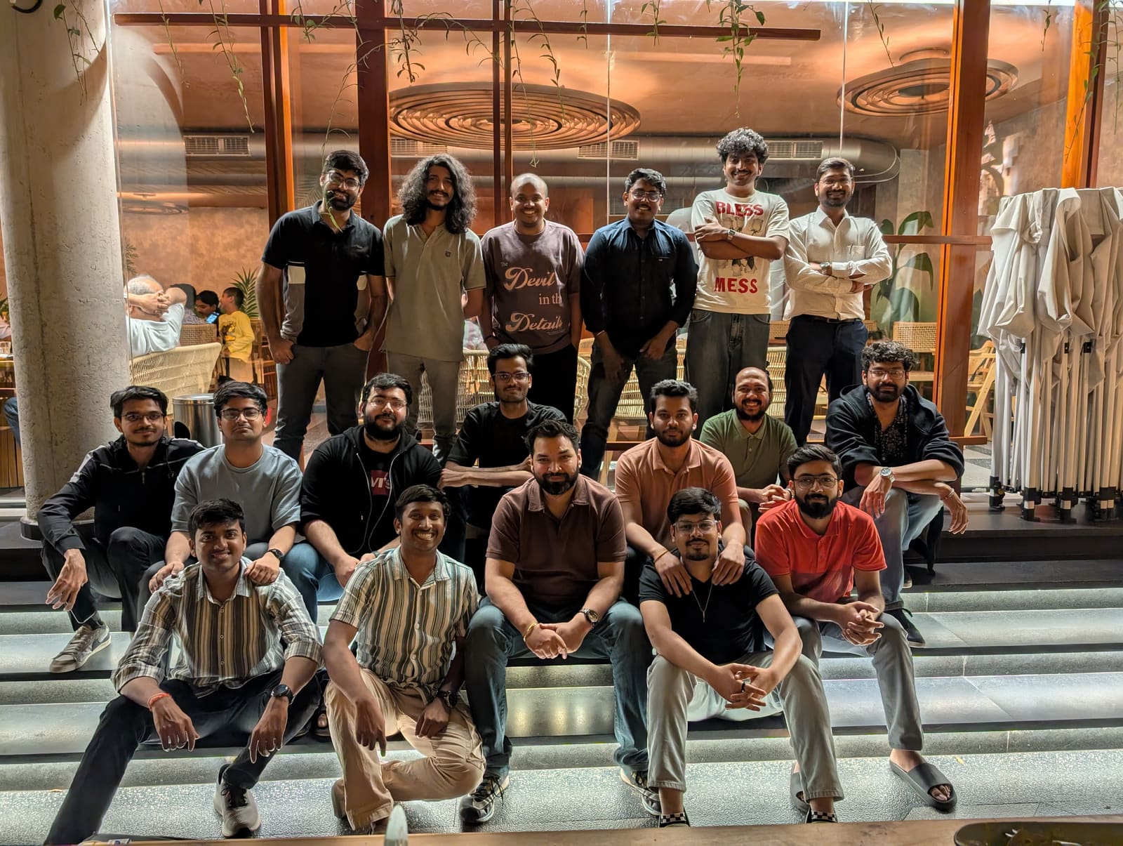 Group photo of the Newton School team on the steps of a restaurant