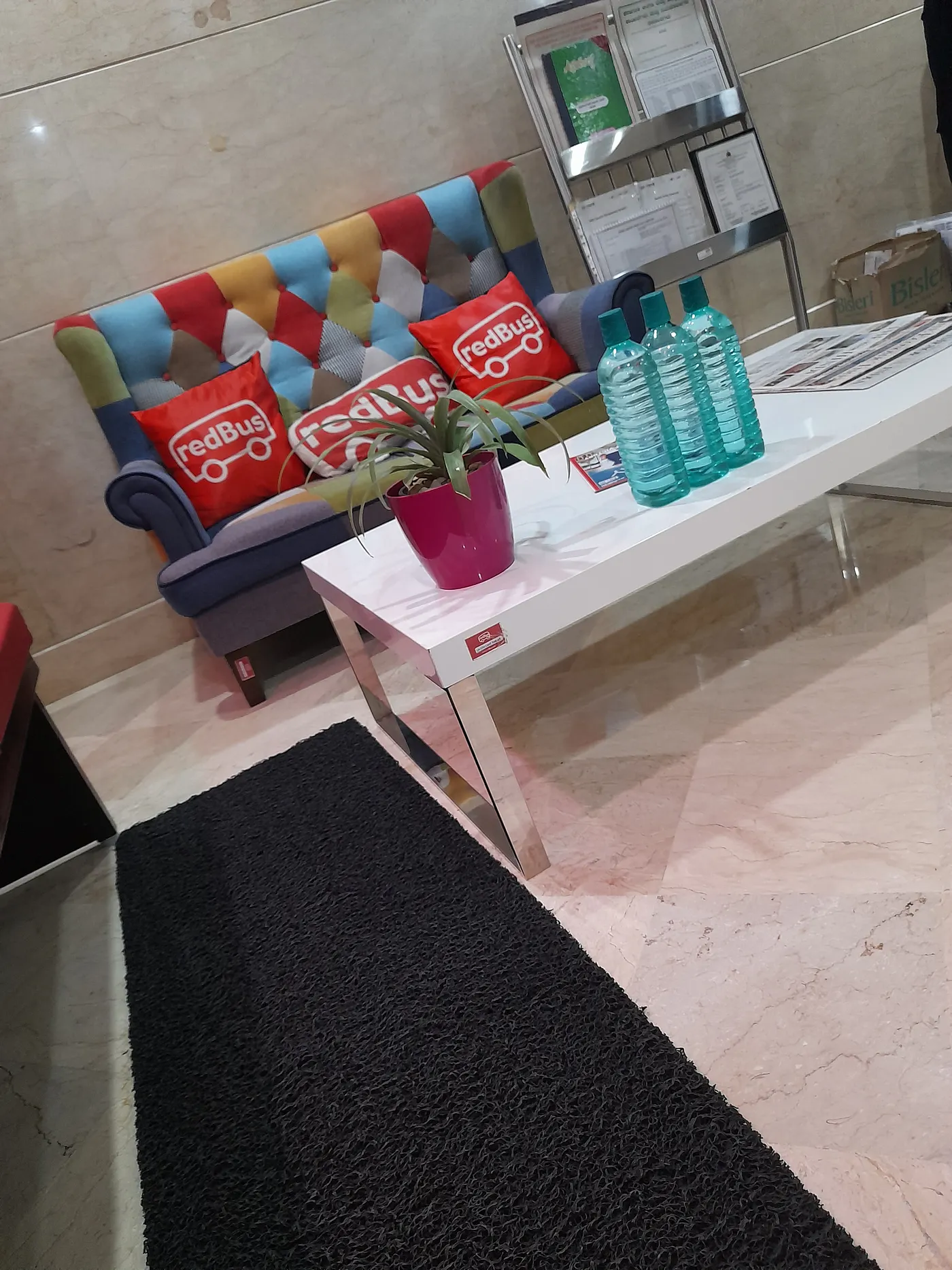 The redBus office reception with redBus cushions on a sofa